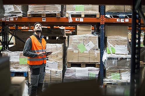 Man recording inventory in a warehouse | Logistics document management