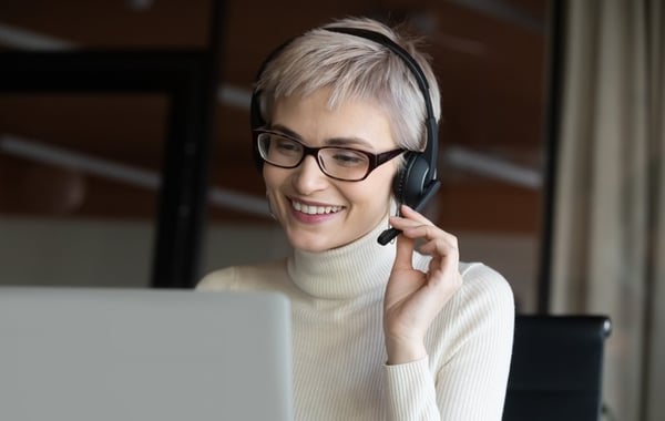 Woman at computer wearing headset