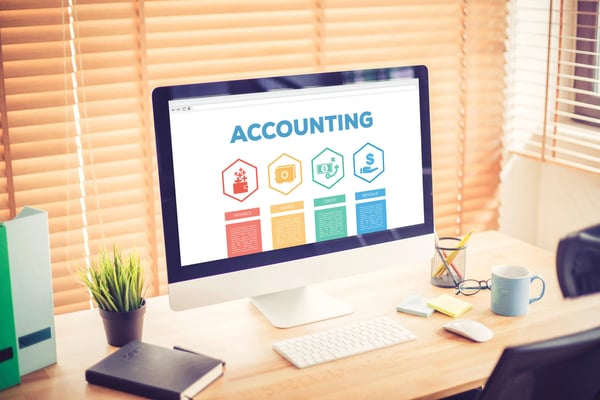 The word accounting and accompanying icons on laptop screen on a neat and attractive desk