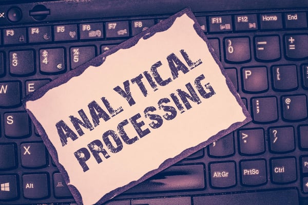 The words Analytical Processing on a background that features a purple computer keyboard