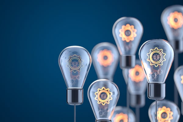 clear light bulbs containing lit gears representing modern technology and data