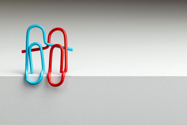 Turquoise and red paper clips paper clips intertwined represent the concept of happy relationship