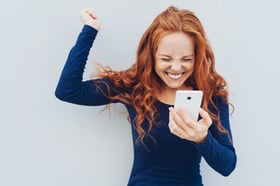 Happy young woman with mobile phone
