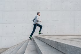 Man climbing stairs represents performance management
