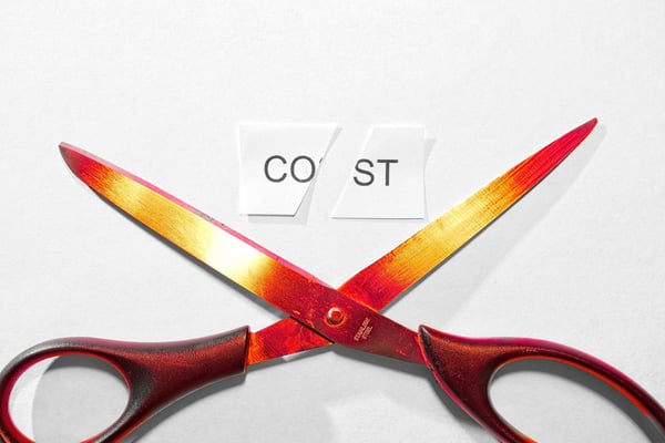 Metallic scissor cutting the word cost