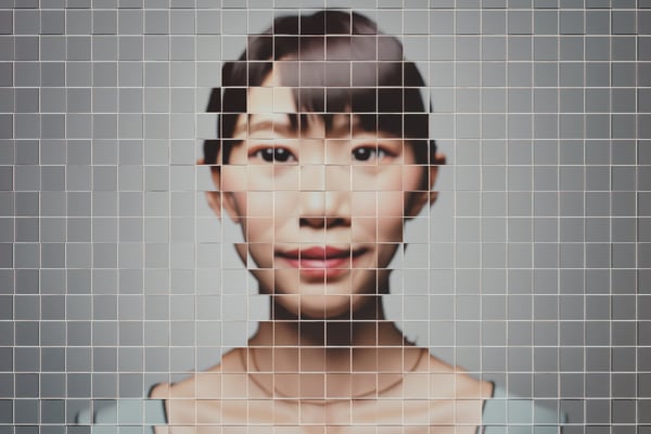 Asian woman shown in a pixalated photo ready to become an avatar