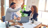 businessman and woman high-fiving