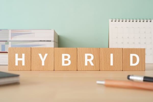 The word hybrid in white on small wooden blocks