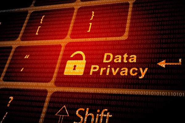 The words data privacy in orange over a red background that contains binary code