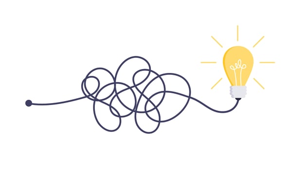 Yellow light bulb with tangled string underneath it shows how an idea can be coming into being out of chaos