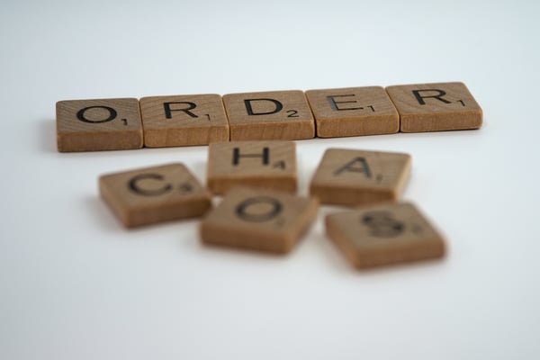 Order and Chaos printed on scrabble tiles