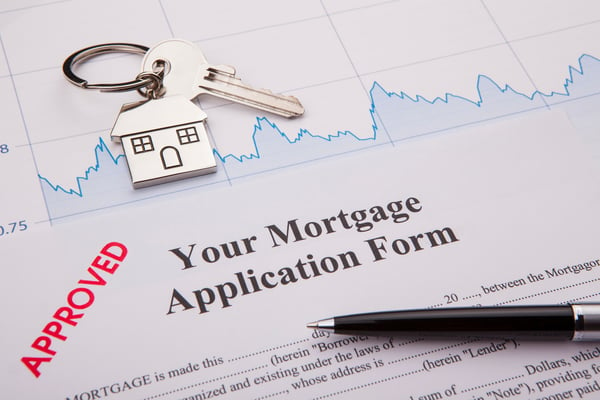 A picture of a mortgage application that must be signed with a pen and paper