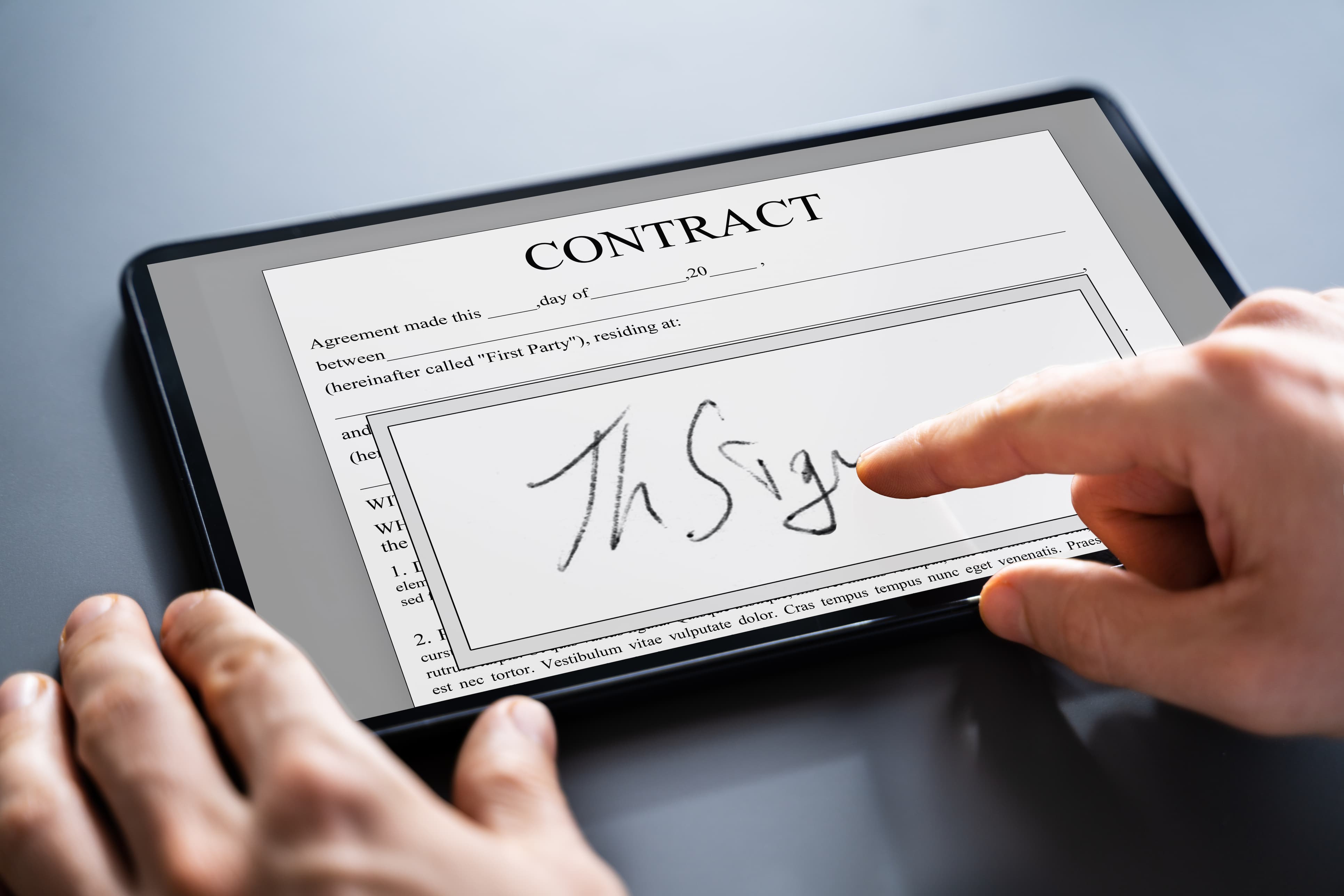 Signing a contract on a tablet with a finger (1)