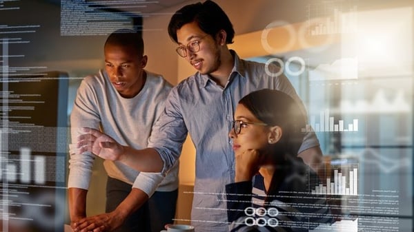 three coworkers looking at a computer