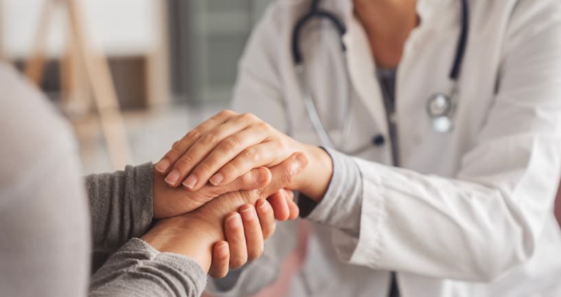Doctor holding the hands of a patient