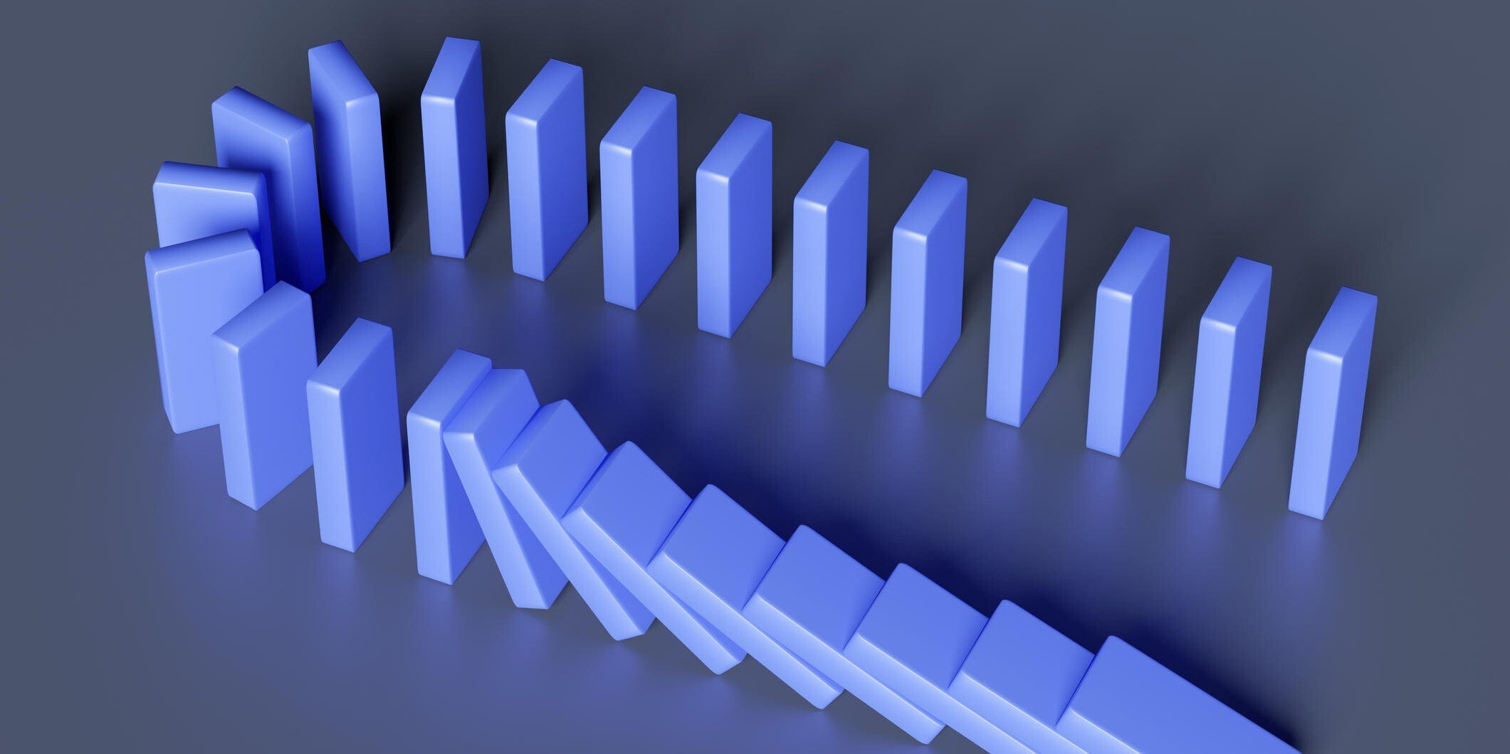 Blue dominos lined up with the first few dominos falling into the ones next to them