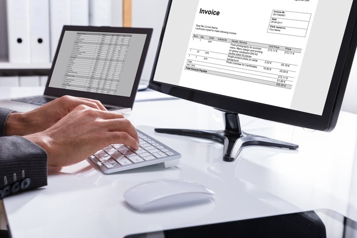 Man-Viewing-Invoice-Digitally-On-Computer