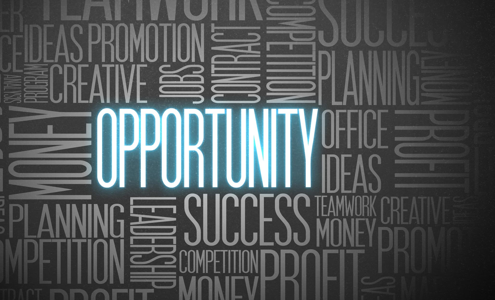 Opportunity in blue neon letters in a word cloud with other business terms