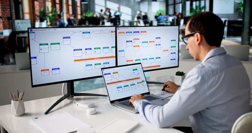 Man Using Laptop To Manage Automated Business Workflow And Data Tasks.