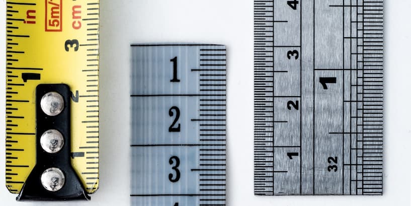yellow measuring tape and gray rulers